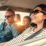 Happy family riding in a car . Happy family riding in a car .