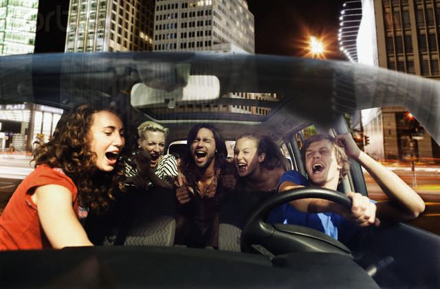 Friends singing in a car --- Image by © Josef Lindau/Corbis
