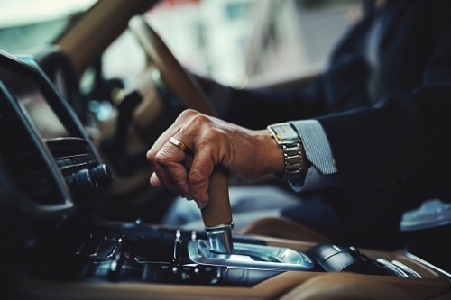 hand on gear and steering wheel