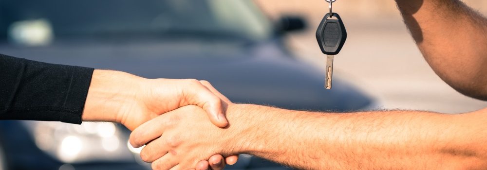 transfer of keys while handshake, car in background